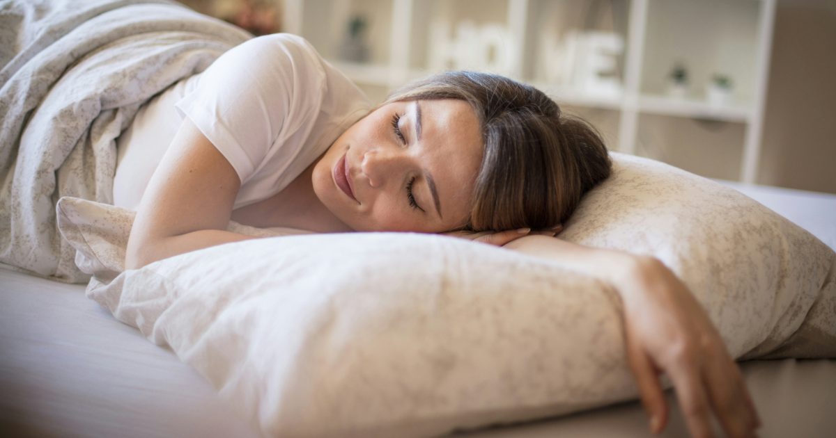 A woman asleep on a soft pillow