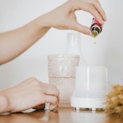 Essential oil being dropped into a white diffuser