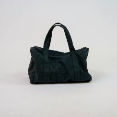 A soft black holdall on a white table
