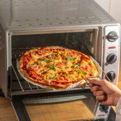 Taking a pizza out of a countertop electric oven