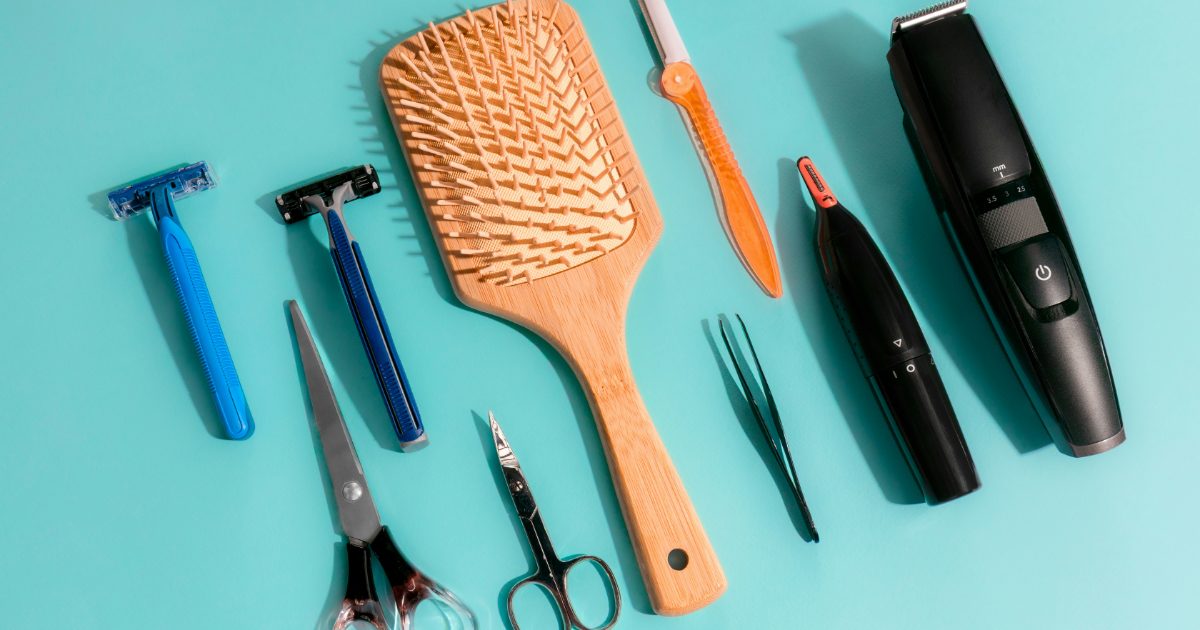 Grooming tools including a nose hair trimmer on turquoise