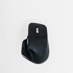 Large black ergonomic mouse with a thumb rest on a white background