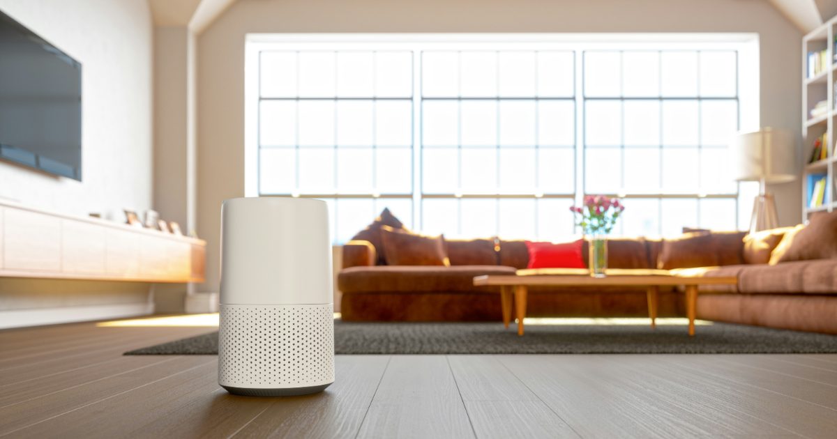 A white air purifier in a bright modern living room