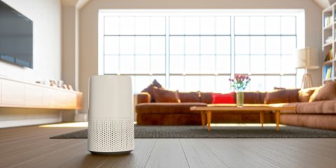 A white air purifier in a bright modern living room