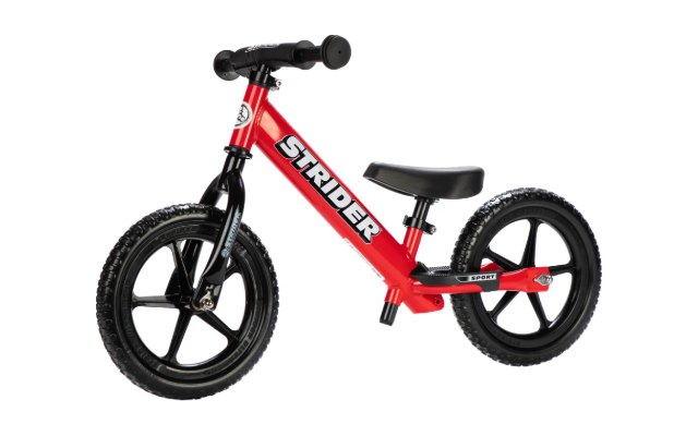 A red Strider 12 Sport balance bike, side on