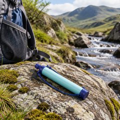 Water filter straw, lying on a rock beside a Lake District stream next to a rucksack