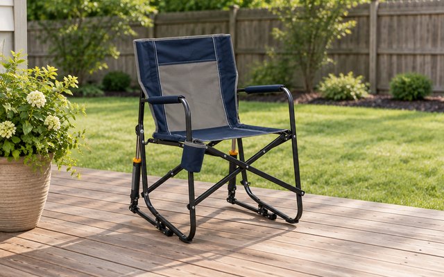GCI Freestyle Rocker, set up on the wooden deck of a suburban backyard beside a potted plant, a lawn and a fence behind