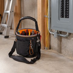 Klein Tools Tradesman Pro tool bag, on the floor of an unfinished basement beside an electrical panel