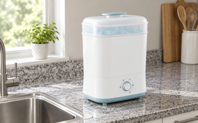 Papablic sterilizer and dryer, on a gray granite counter next to a stainless steel sink in a family kitchen