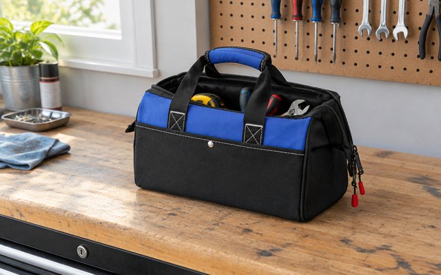WORKPRO wide-mouth tool bag, open on a garage workbench with a few tools inside