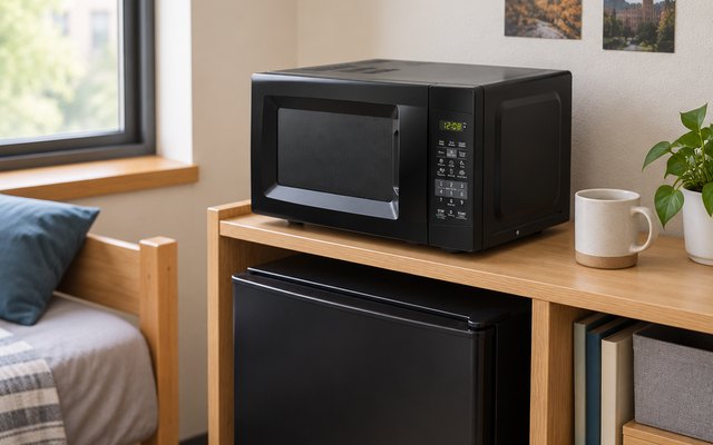 COMFEE' 0.7 cu ft microwave, on a dorm room shelf unit beside a mini fridge and a mug