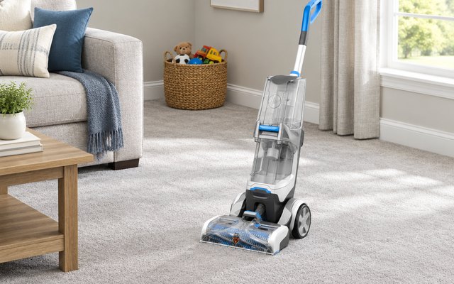 Upright carpet cleaner on a light grey living room carpet near a sofa