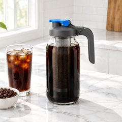 County Line Kitchen 64 oz cold brew maker, steeping on a sunny breakfast counter beside a glass of iced coffee