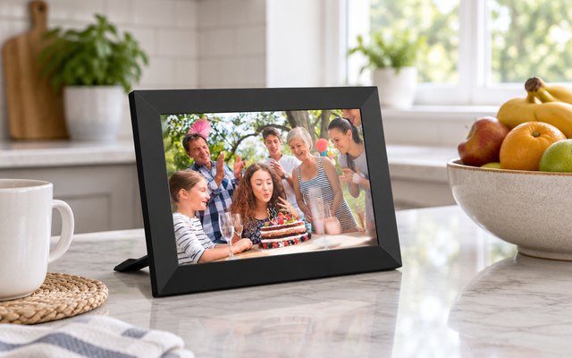 AKImart Frameo 10.1-inch Wi-Fi Digital Photo Frame, on a kitchen counter near a fruit bowl