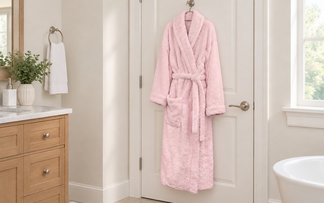 PAVILIA teddy sherpa robe, hanging from a hook on a bathroom door