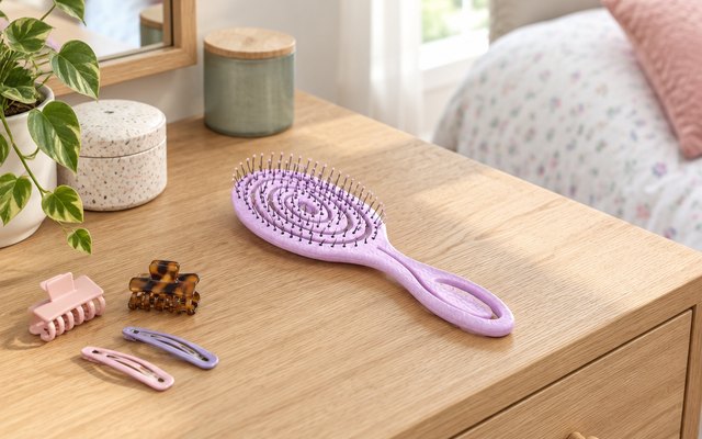 Ninabella detangling brush, on a dressing table in a family bedroom beside a few hair clips