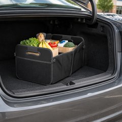 Sposuit collapsible trunk organizer, in the open trunk of a sedan in a supermarket parking lot
