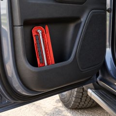 Pair of pencil tire pressure gauges, in the open door pocket of a pickup truck