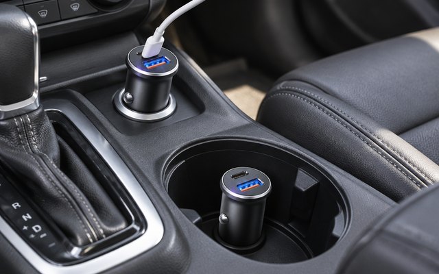 LISEN 69W car chargers, with one plugged into the 12-volt socket of a sedan's center console and the other lying in the cup holder beside it