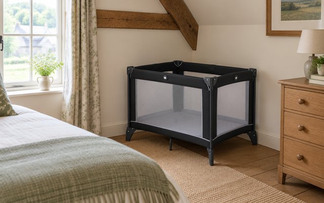 Graco compact travel cot, in a cottage bedroom with beams