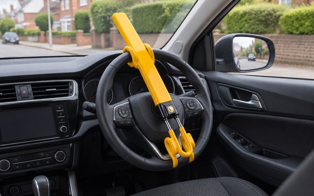 Twin bar steering wheel lock, clamped across a car's steering wheel