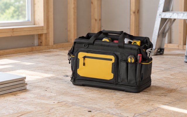 DEWALT 20-inch tool bag, on a plywood subfloor in a home being renovated