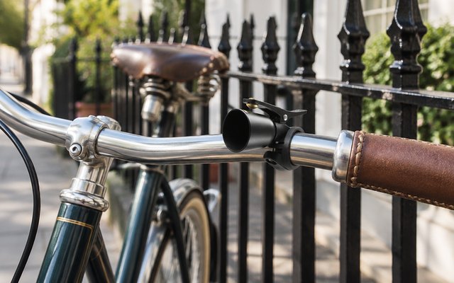 ROCKBROS copper bike bell, on a town bike by iron railings
