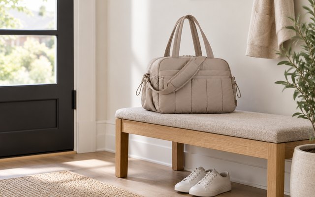 BAGSMART 24L gym bag, on an entryway bench by the front door, a pair of plain white sneakers on the floor below