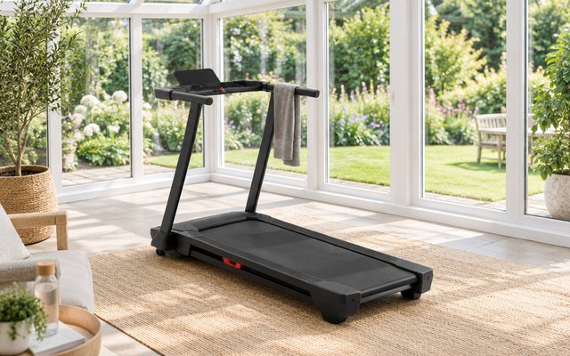 NordicTrack T Series 5 treadmill, in a bright conservatory looking onto a garden, a towel over the handrail