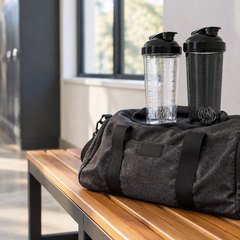 VELOMIX shaker bottles, the two bottles on top of a gym bag on a hallway bench
