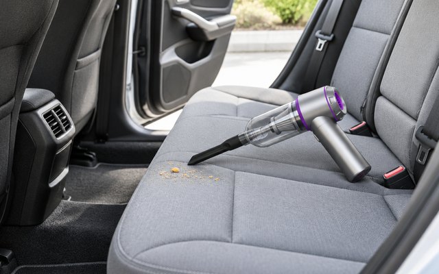 Cordless handheld vacuum on a car's back seat