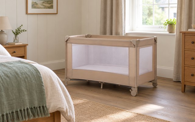 Travel cot, in a holiday cottage bedroom