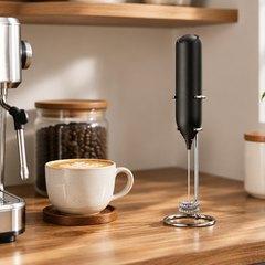 CIRCLE JOY milk frother, on a home coffee bar shelf beside an espresso machine and a latte cup